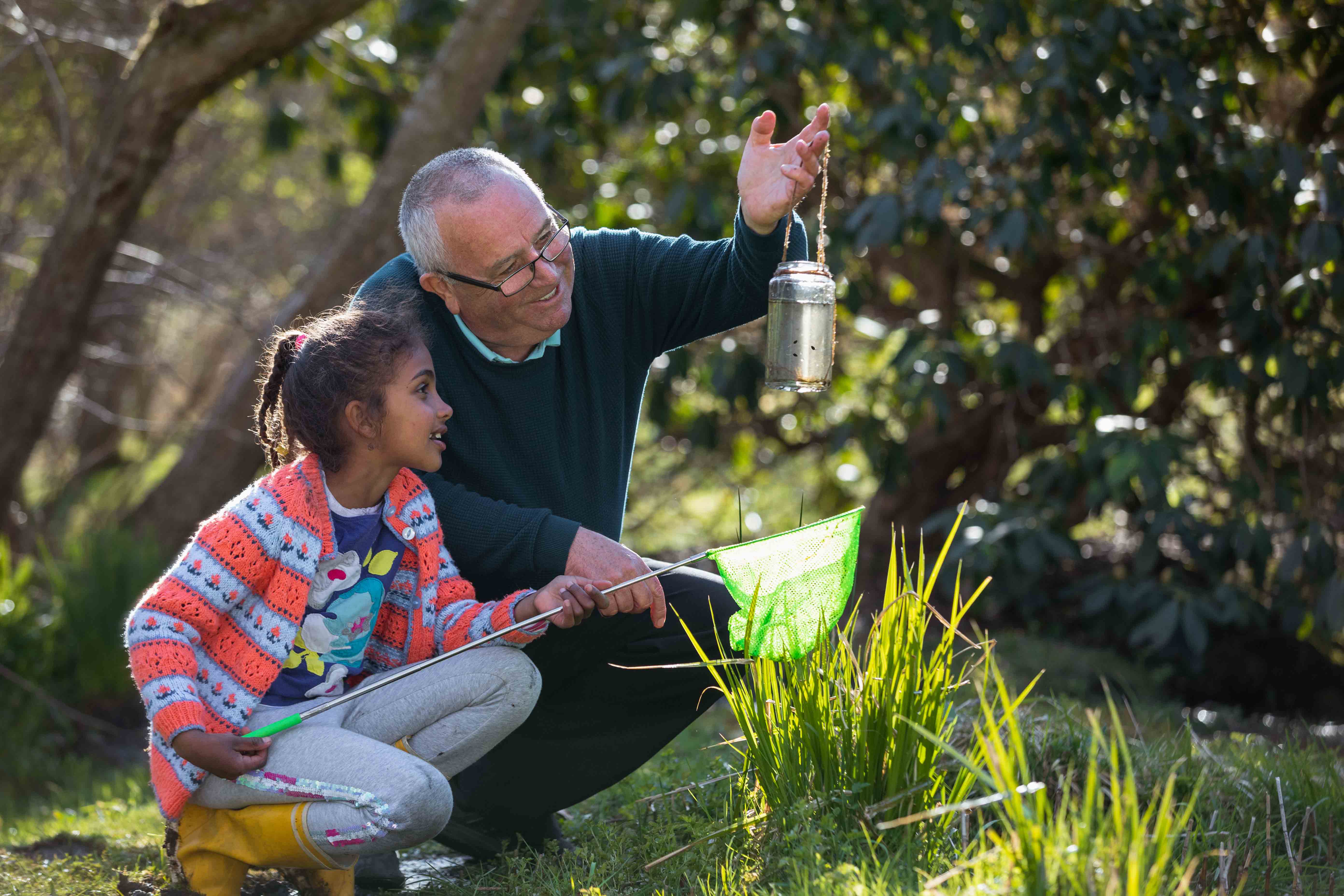 InnocentDrinks, child and older man looking at jar
