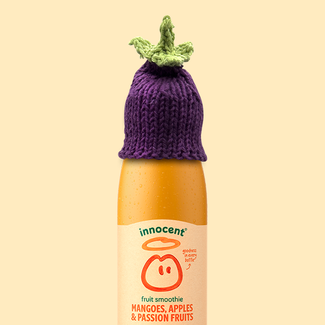 Here's a smoothie bottle with a aubergine hat on it. 