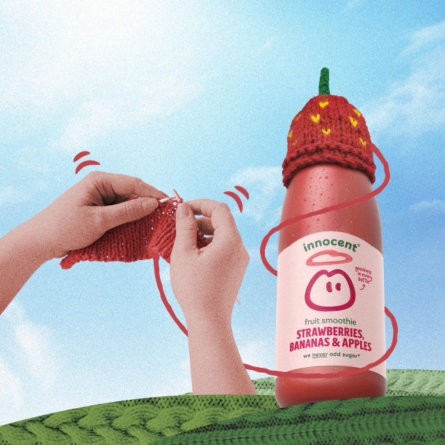 Here's a smoothie bottle with a strawberry hat on. 